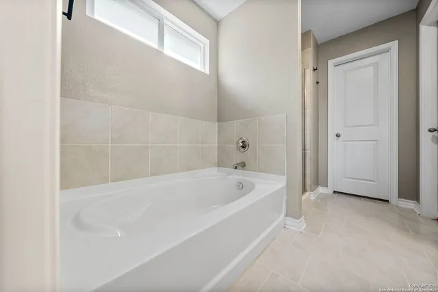 a white bath tub sitting in a bathroom