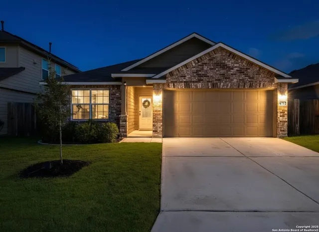 a front view of house with yard and green space