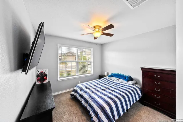 a bedroom with a bed dresser and a window