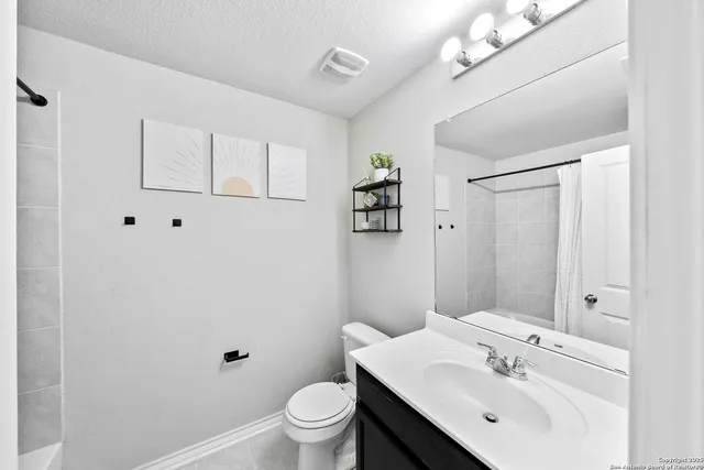 a bathroom with a sink toilet and vanity