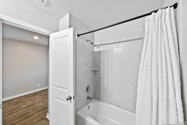 a bathroom with a shower and a tub