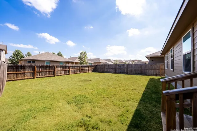 a view of a swimming pool and a yard
