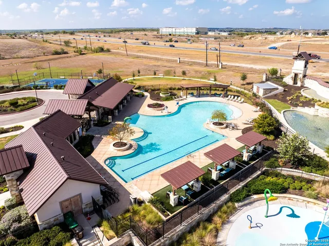 a view of a balcony with outdoor seating and ocean view