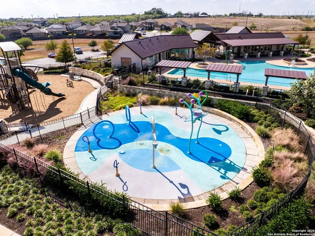 an aerial view of a swimming pool patio and lake view