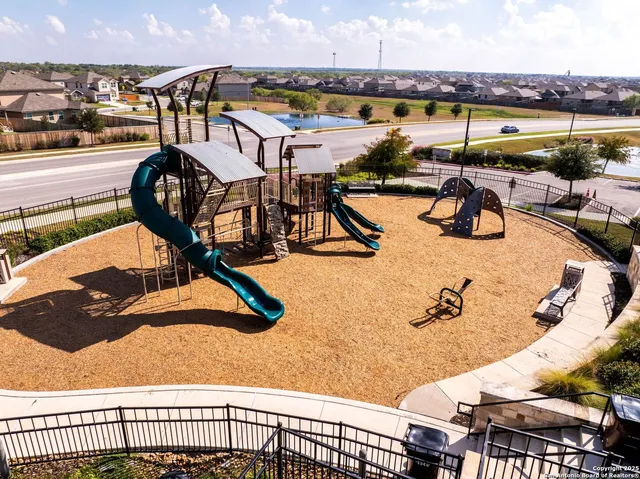 a view of a swimming pool with outdoor seating and a ocean view