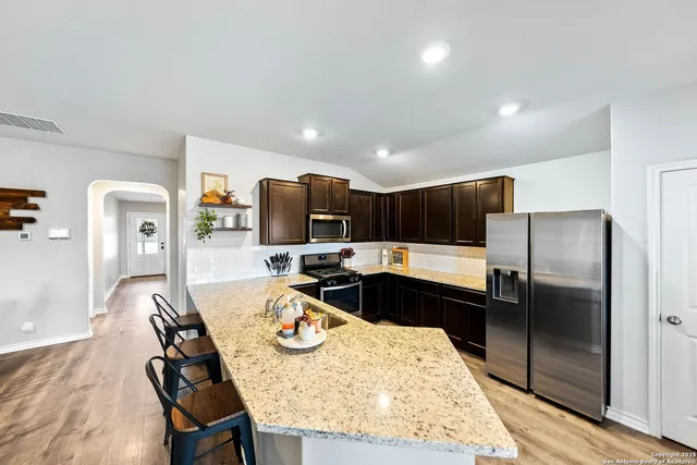 a kitchen with a refrigerator and a sink