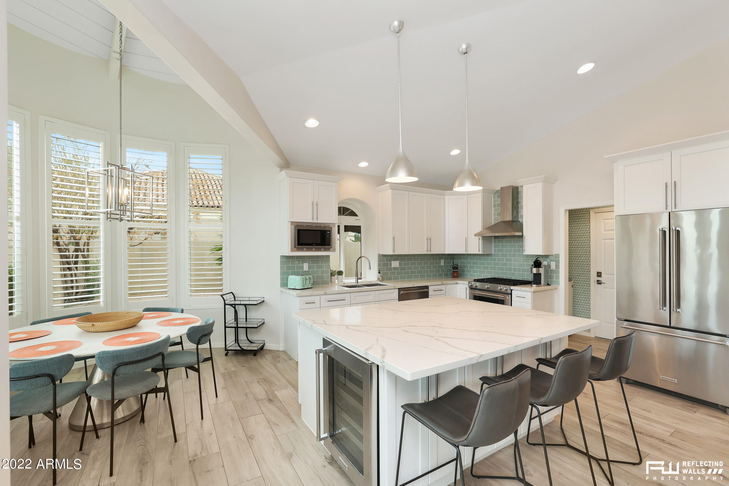 10085 East Doubletree Ranch Road Scottsdale, AZ 85258 - Photo 14 of 62 a kitchen with stainless steel appliances a table chairs refrigerator and microwave