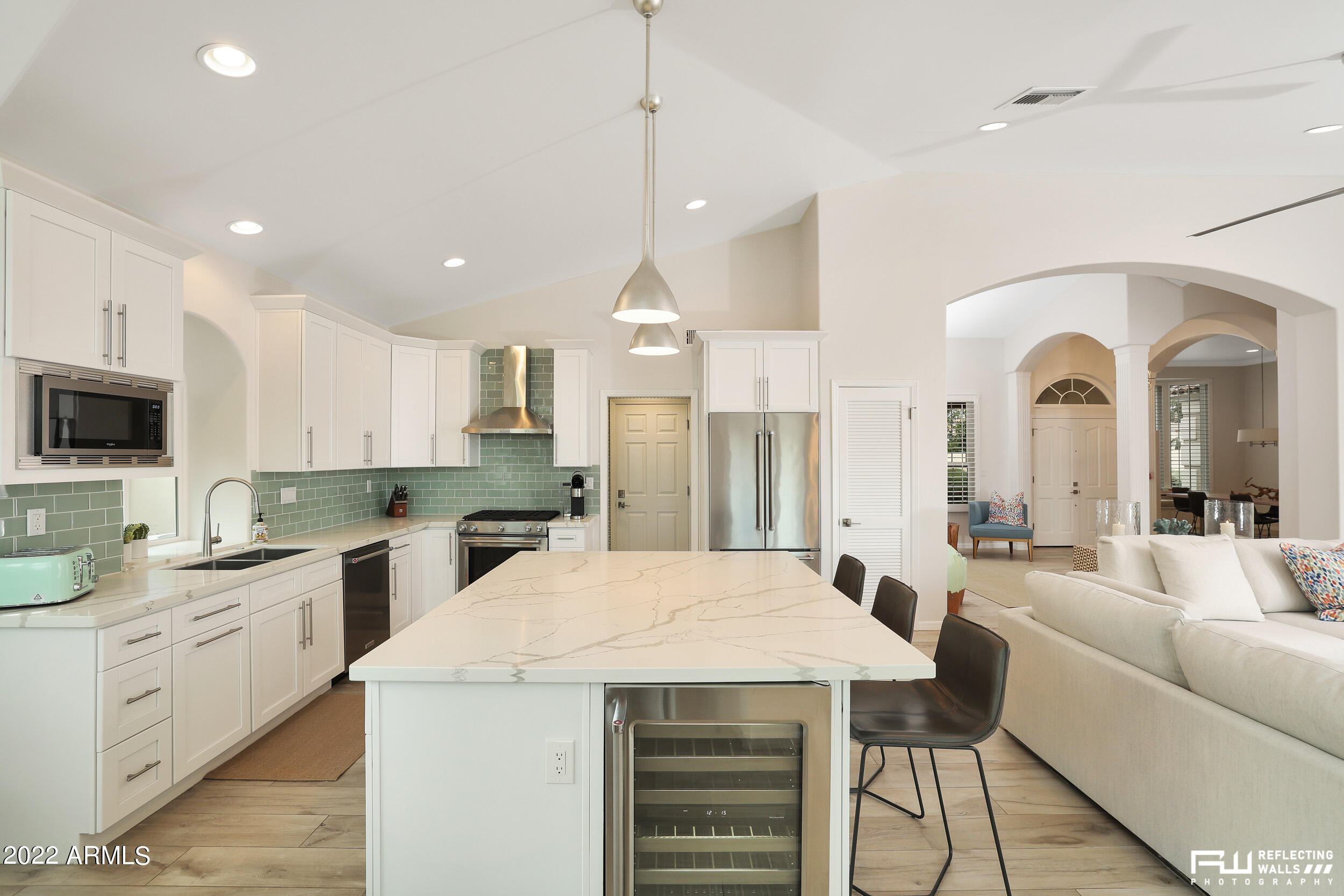 10085 East Doubletree Ranch Road Scottsdale, AZ 85258 - Photo 16 of 62 a living room with stainless steel appliances kitchen island granite countertop a dining table and chairs
