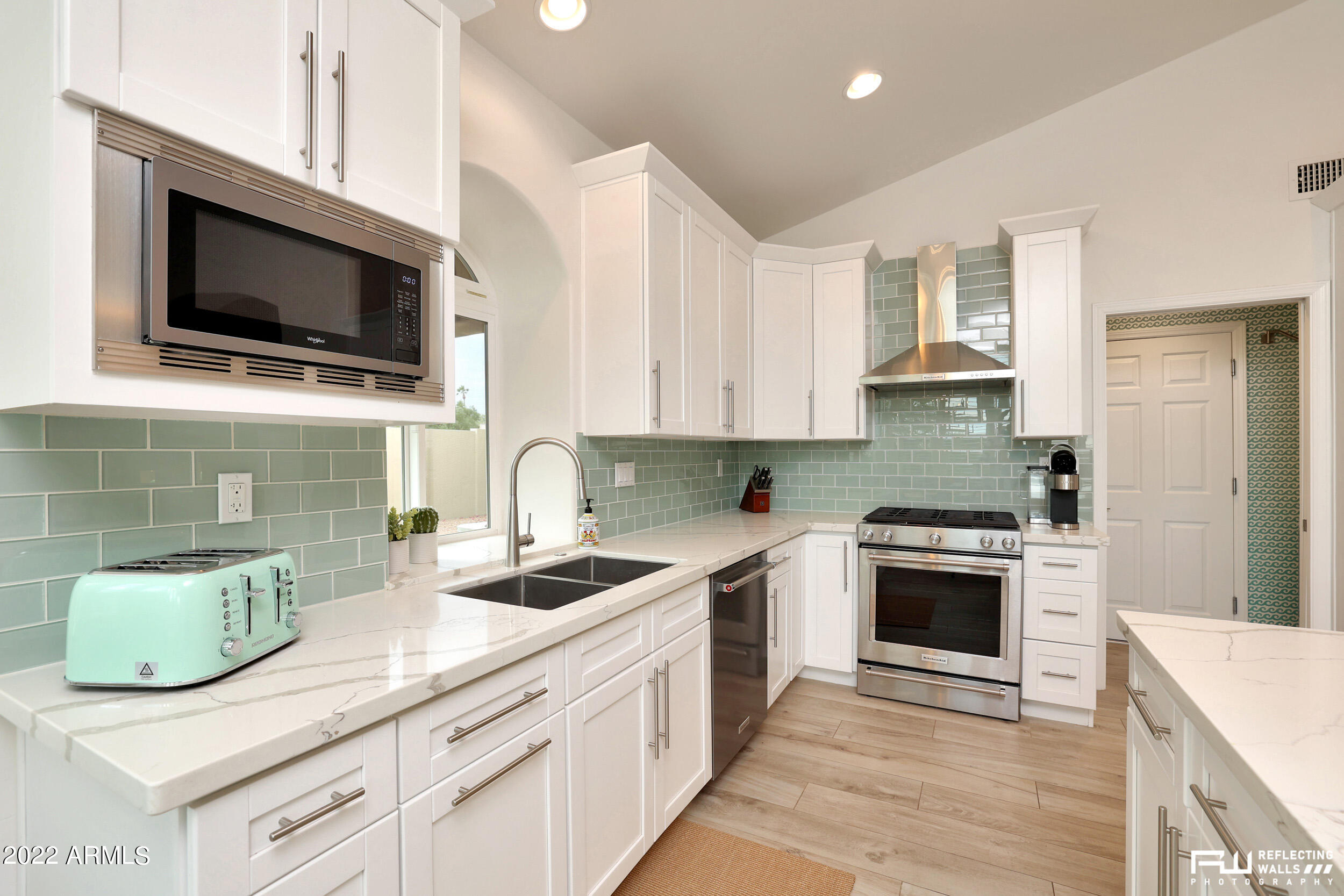 10085 East Doubletree Ranch Road Scottsdale, AZ 85258 - Photo 17 of 62 a kitchen with a sink stove and microwave