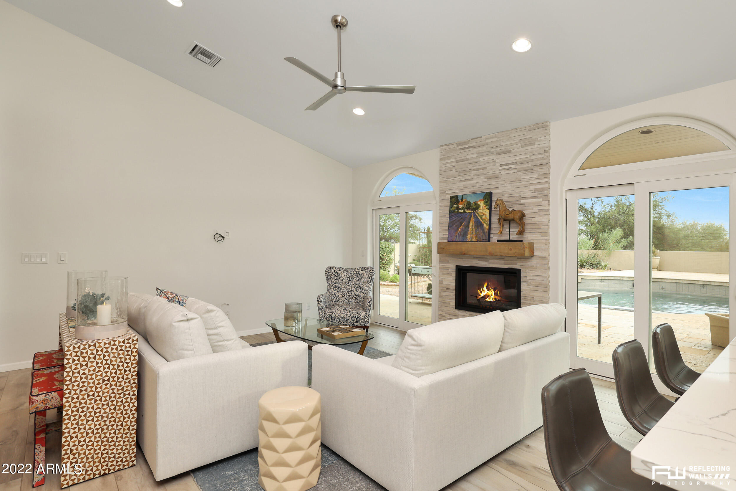 10085 East Doubletree Ranch Road Scottsdale, AZ 85258 - Photo 19 of 62 a living room with furniture a fireplace and a large window