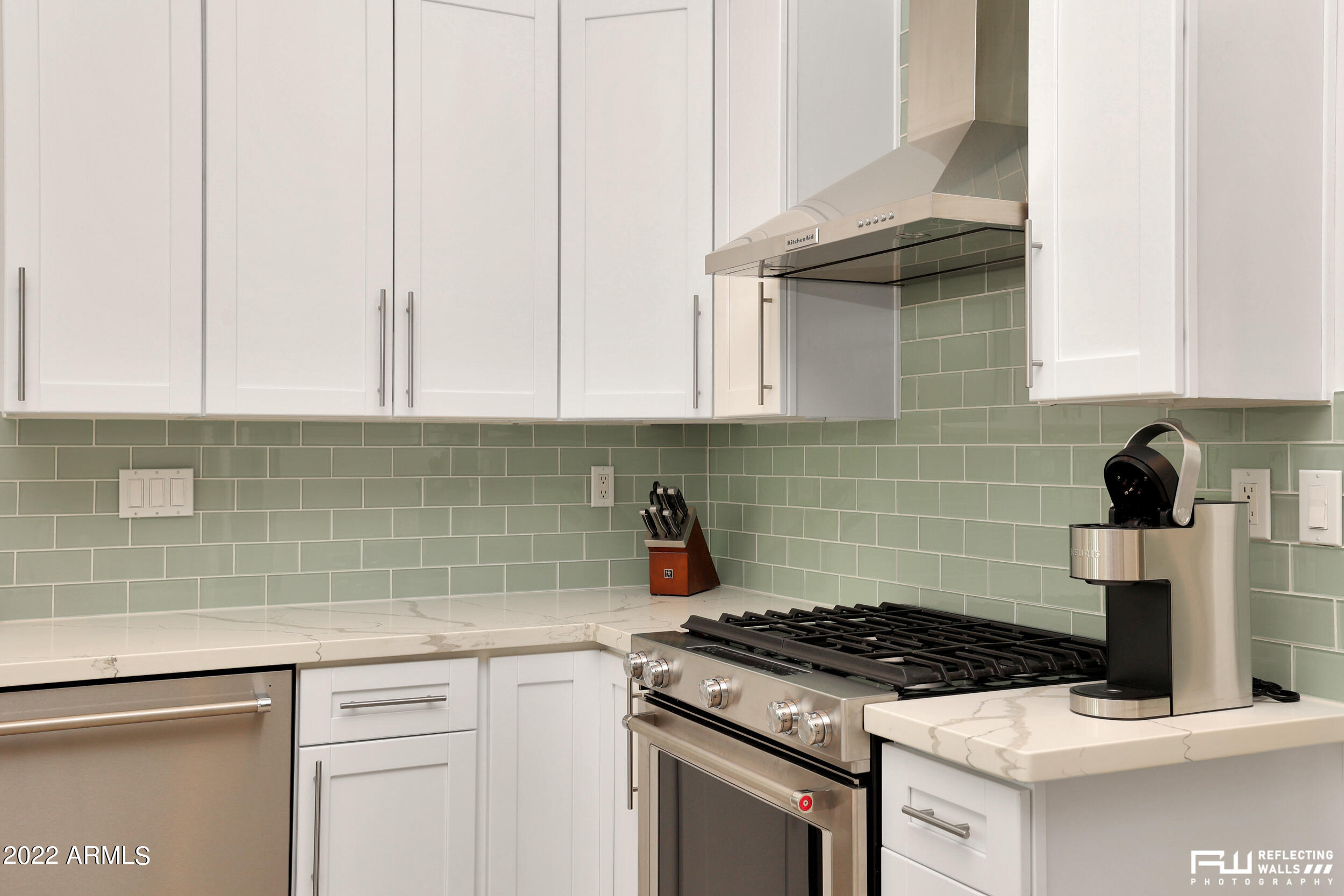 10085 East Doubletree Ranch Road Scottsdale, AZ 85258 - Photo 21 of 62 a kitchen with white cabinets and appliances