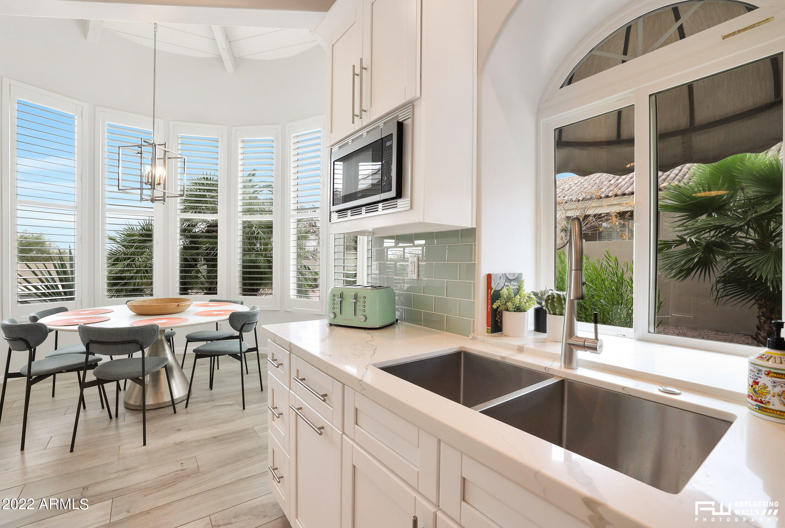 10085 East Doubletree Ranch Road Scottsdale, AZ 85258 - Photo 23 of 62 a kitchen with stainless steel appliances granite countertop a sink and a stove next to a window