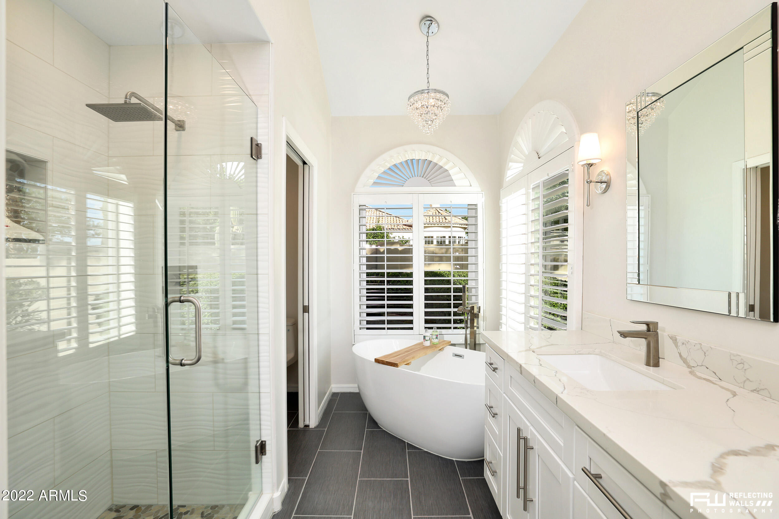 10085 East Doubletree Ranch Road Scottsdale, AZ 85258 - Photo 36 of 62 a spacious bathroom with a granite countertop sink a mirror and a shower