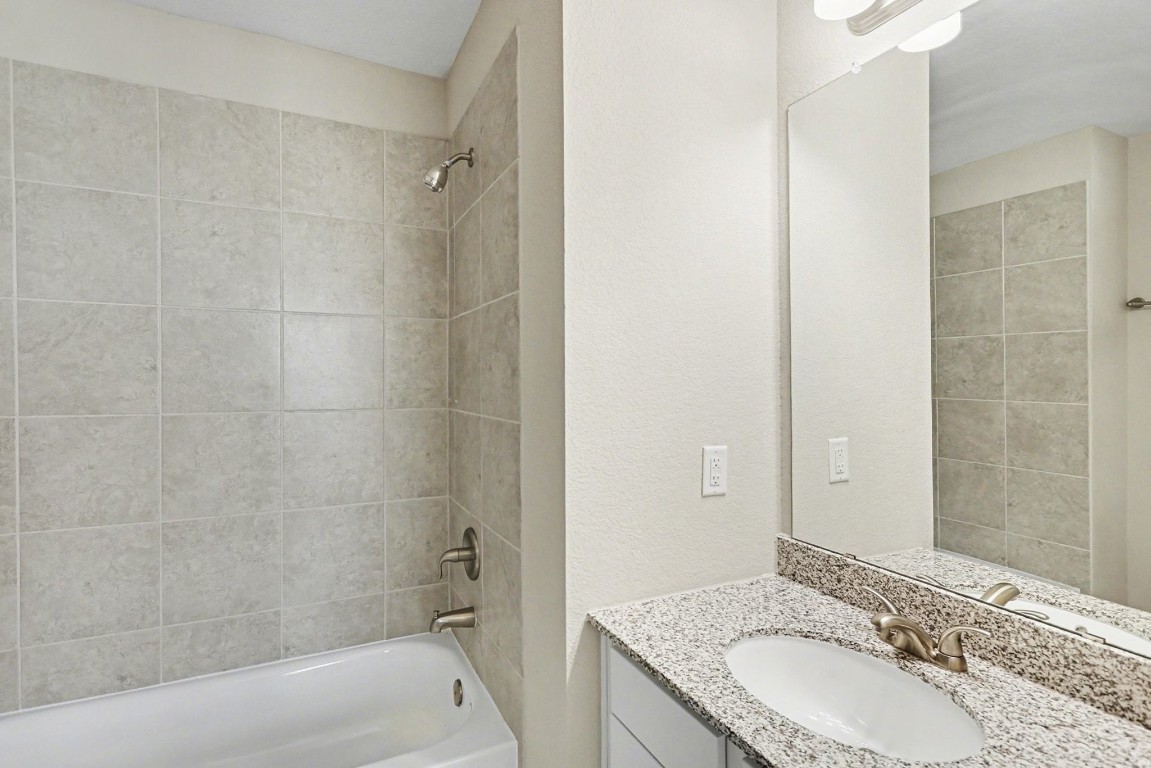 19602 Pradera Meadows Loop Rosharon, TX 77583 - Photo 27 of 47 a bathroom with a granite countertop sink a toilet and shower