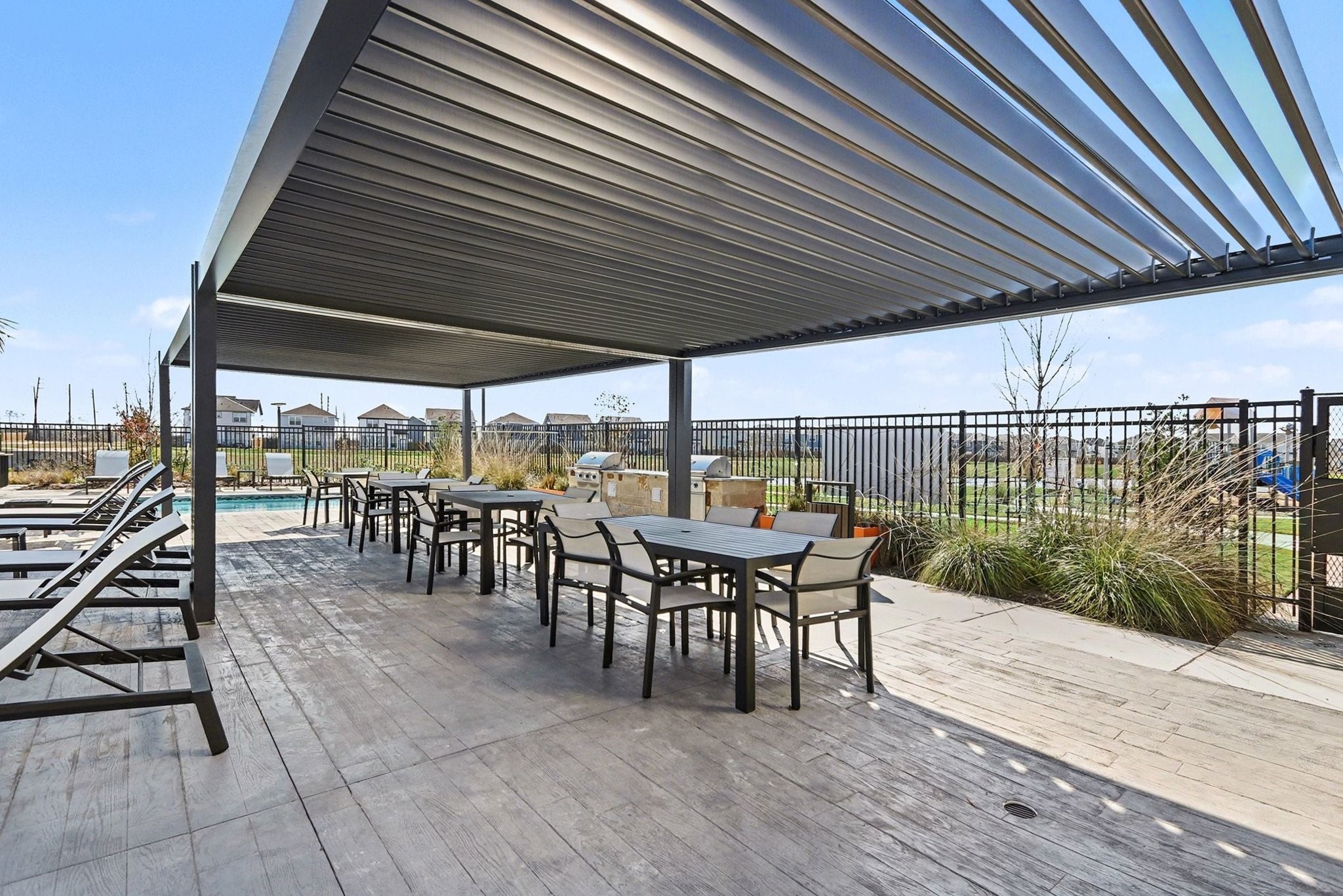 19602 Pradera Meadows Loop Rosharon, TX 77583 - Photo 36 of 47 a view of a patio with table and chairs with wooden floor and fence