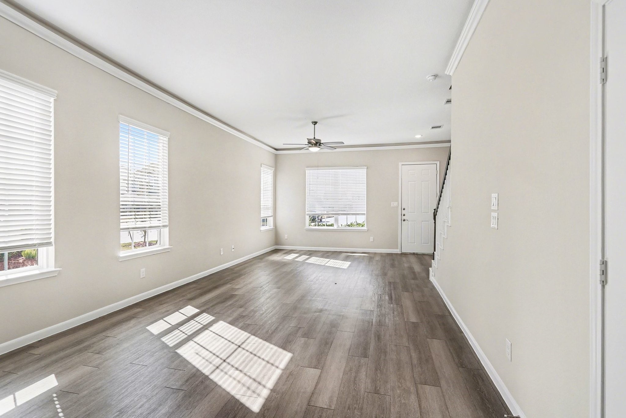 19602 Pradera Meadows Loop Rosharon, TX 77583 - Photo 6 of 47 an empty room with wooden floor and windows