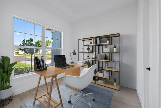 a view of a workspace with furniture and a potted plant