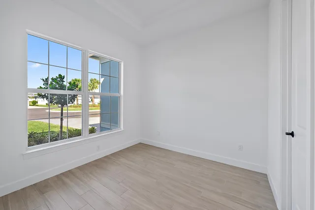 a view of room with window and wooden floor