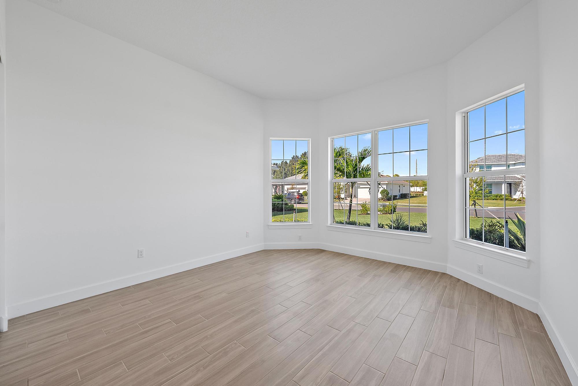 9801 Southwest Legacy Drive Stuart, FL 34997 - Photo 20 of 46 wooden floor in an empty room with a window