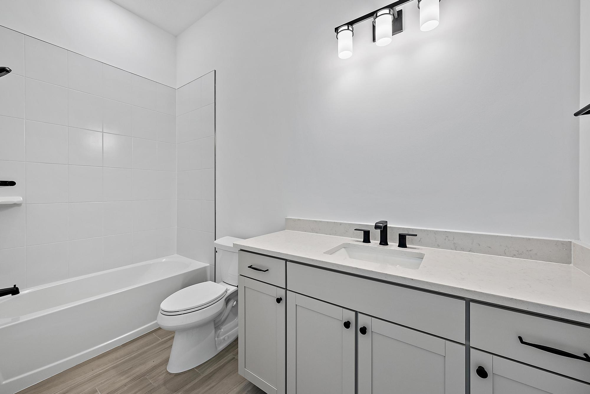 9801 Southwest Legacy Drive Stuart, FL 34997 - Photo 21 of 46 a bathroom with a sink toilet and vanity