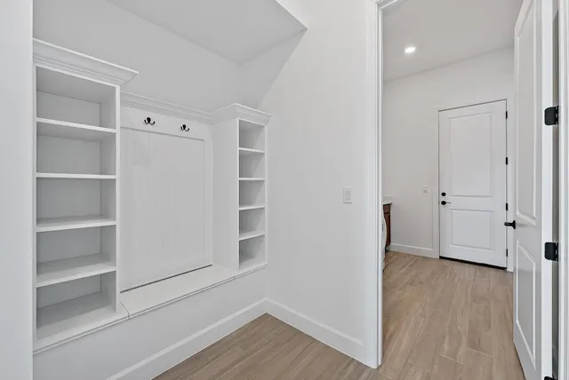 a view of empty room with wooden floor