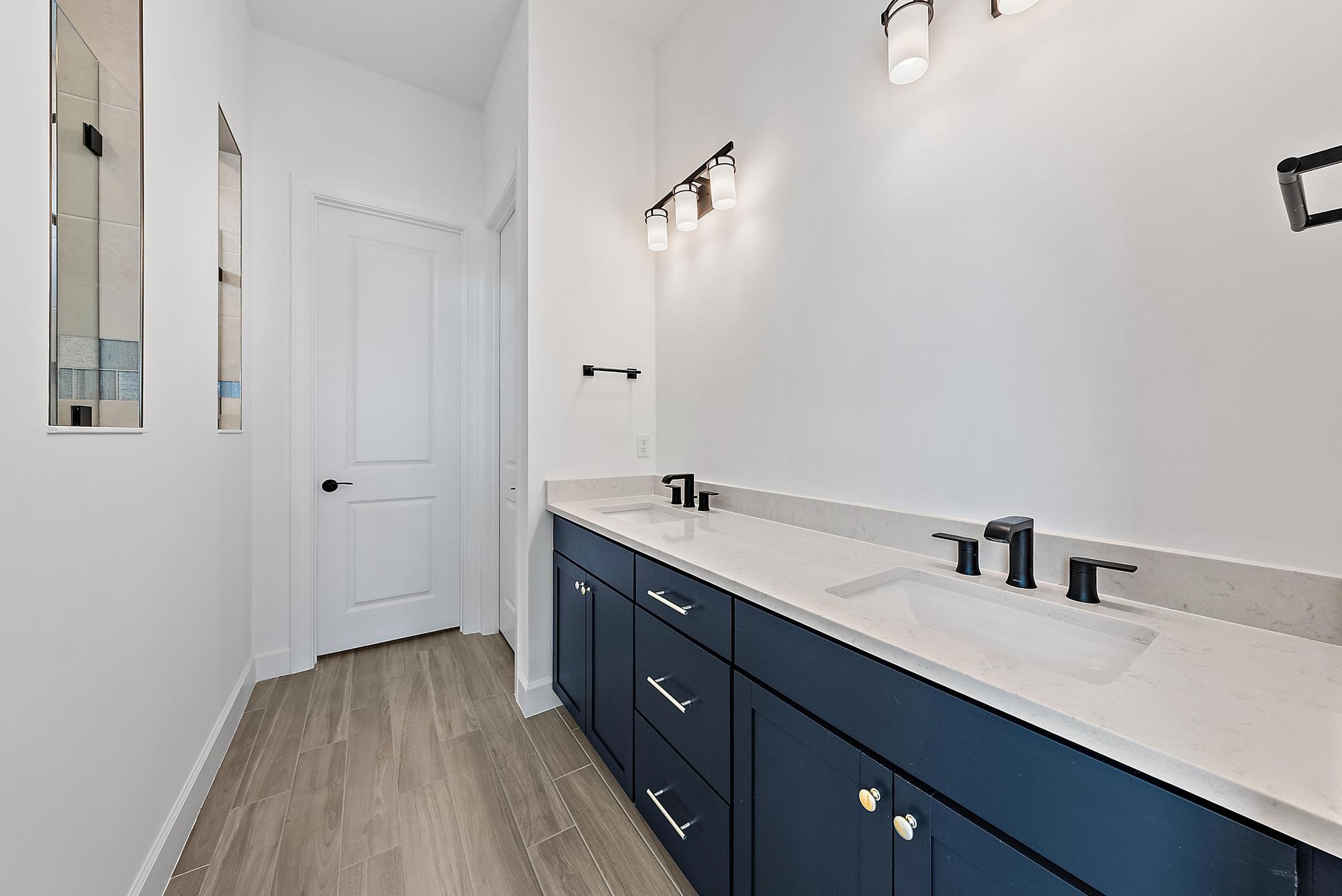 9801 Southwest Legacy Drive Stuart, FL 34997 - Photo 30 of 46 a bathroom with a double vanity sink and mirror