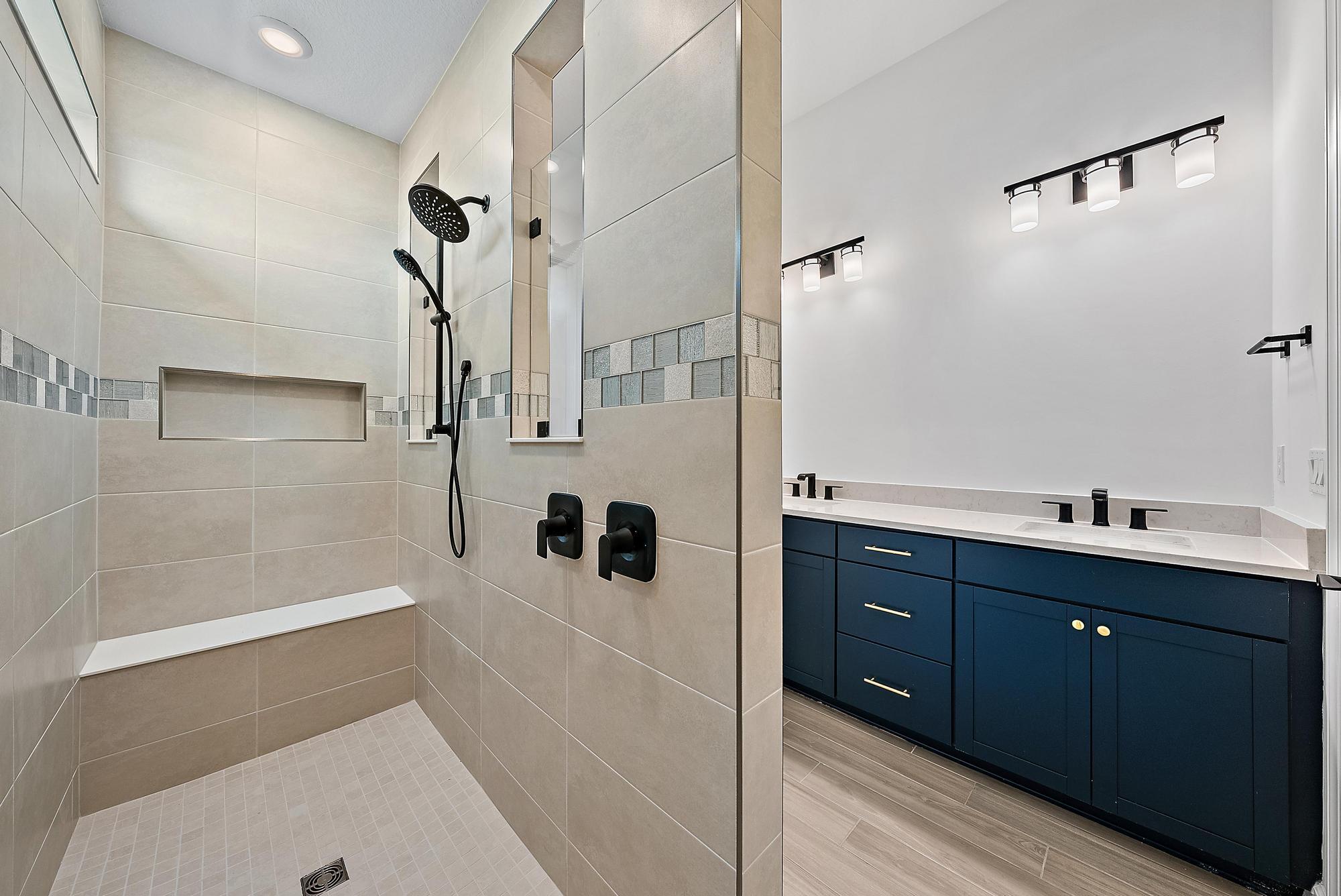 9801 Southwest Legacy Drive Stuart, FL 34997 - Photo 31 of 46 a bathroom with a tub sink and mirror