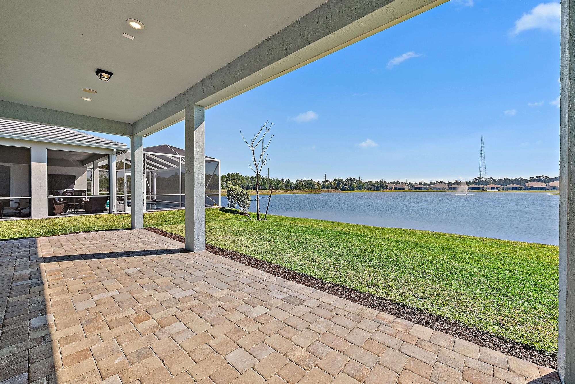 9801 Southwest Legacy Drive Stuart, FL 34997 - Photo 34 of 46 a view of a house with a big yard and potted plants
