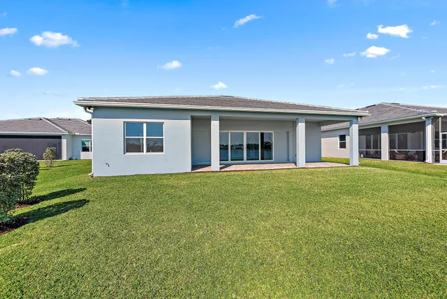 a view of a house with a backyard