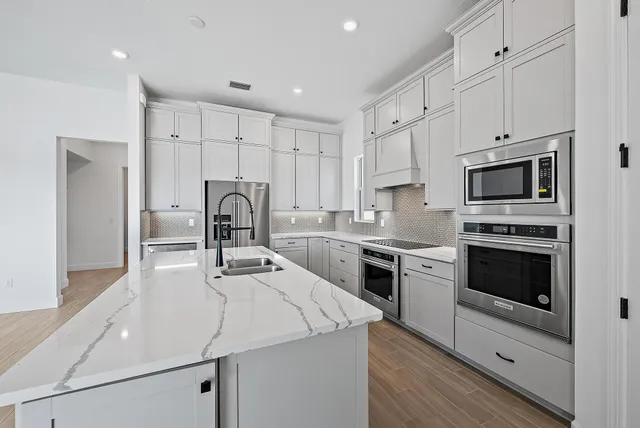 a kitchen with a sink appliances and cabinets