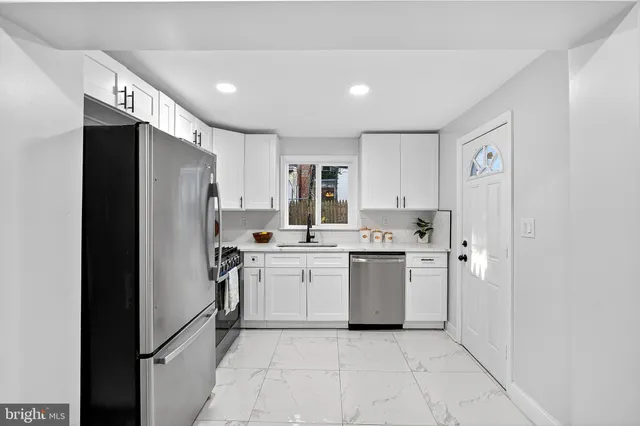 a kitchen with a refrigerator and a sink