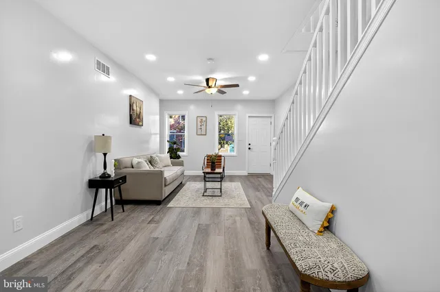 a living room with furniture and wooden floor