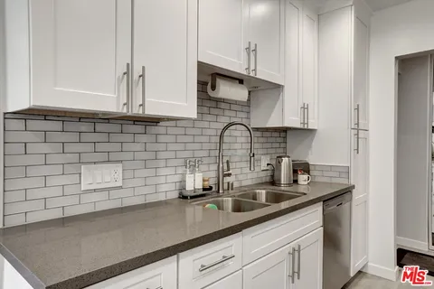 a kitchen with a sink and cabinets