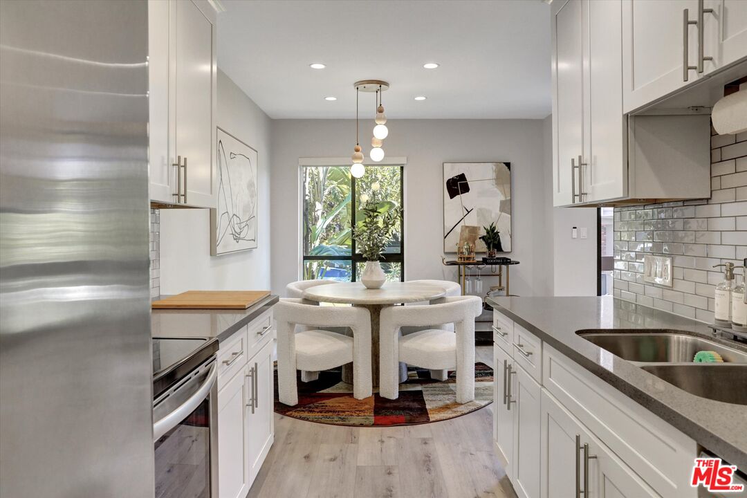 7300 Franklin Avenue, Unit 346 Los Angeles, CA 90046 - Photo 12 of 22 a kitchen with a sink stove and cabinets