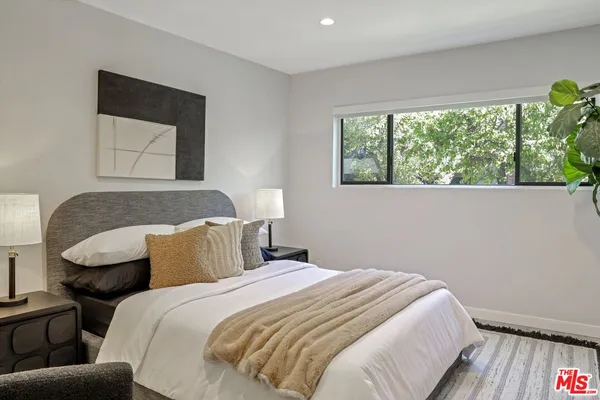 a bedroom with a bed and a couch