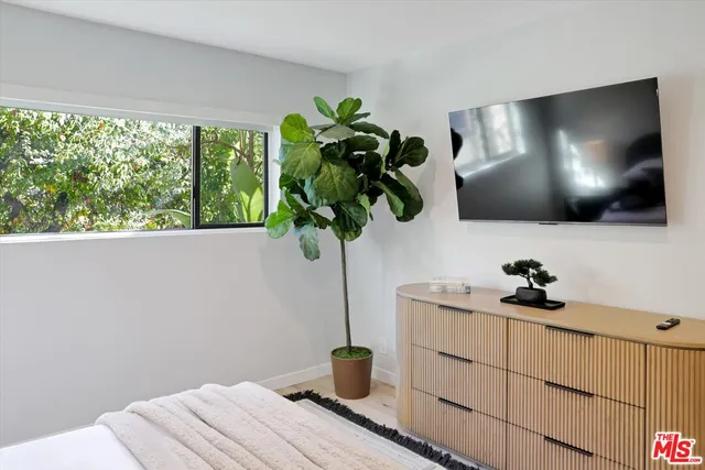 a view of living room with a flat screen tv and floor to ceiling window