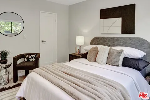 a bedroom with a bed and a chair