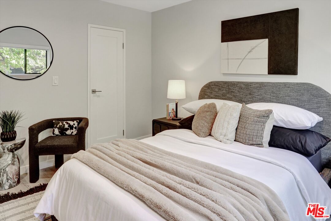 7300 Franklin Avenue, Unit 346 Los Angeles, CA 90046 - Photo 15 of 22 a bedroom with a bed and a chair
