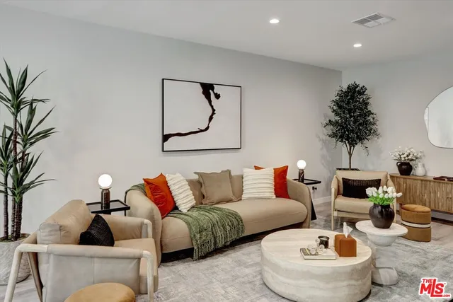 a living room with furniture and a potted plant