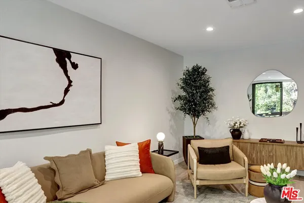 a living room with furniture and a potted plant