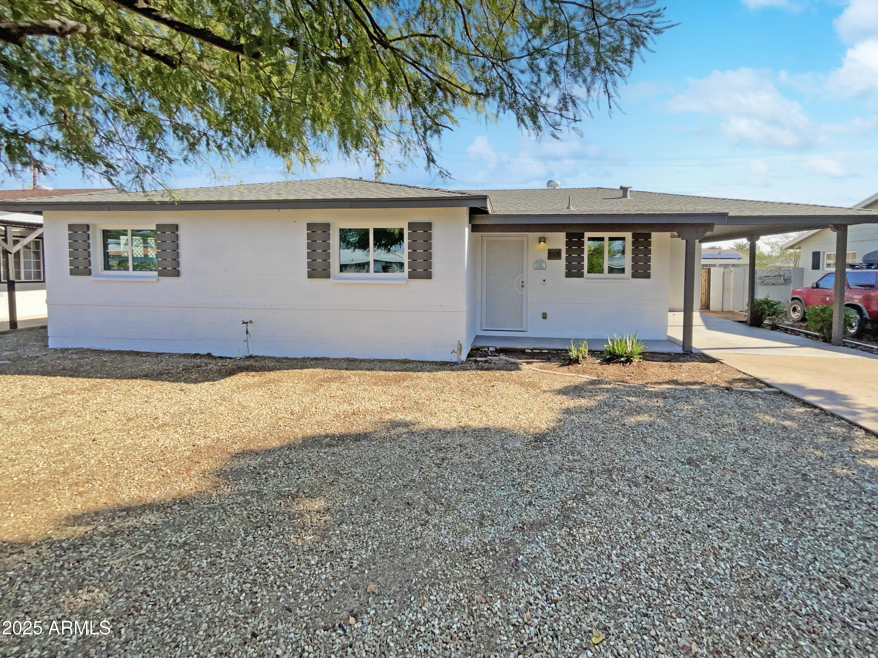 7231 North 23rd Avenue Phoenix, AZ 85021 - Photo 22 of 28 a front view of house with yard and trees in the background