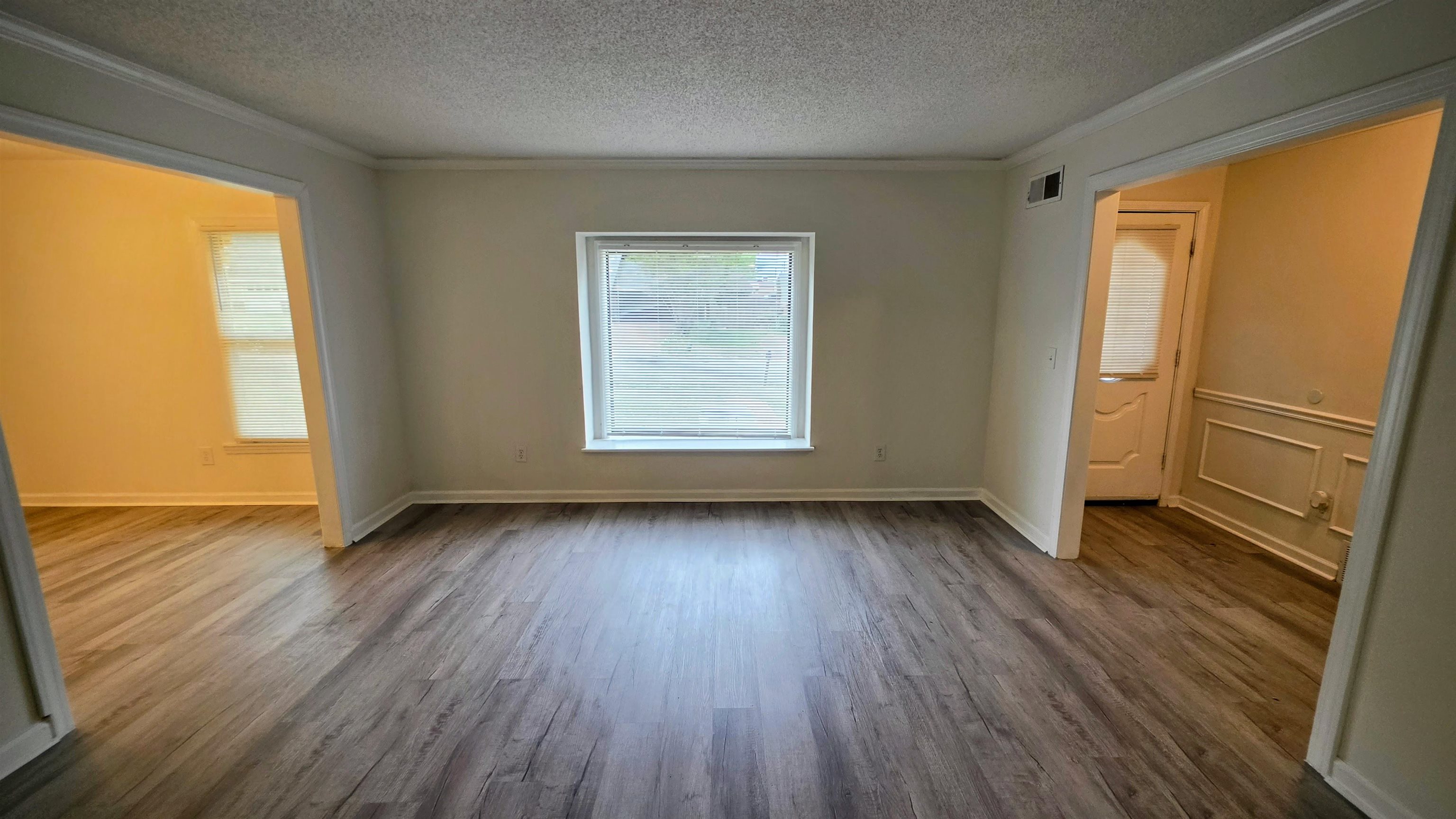 4264 Timber Rise Road Memphis, TN 38125 - Photo 23 of 32 Spare room with dark wood-style flooring, ornamental molding, and a textured ceiling
