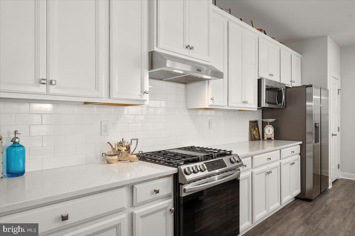 65 Old Forge Drive Ocean View, DE 19970 - Photo 16 of 69 a kitchen with stainless steel appliances granite countertop white cabinets and a stove