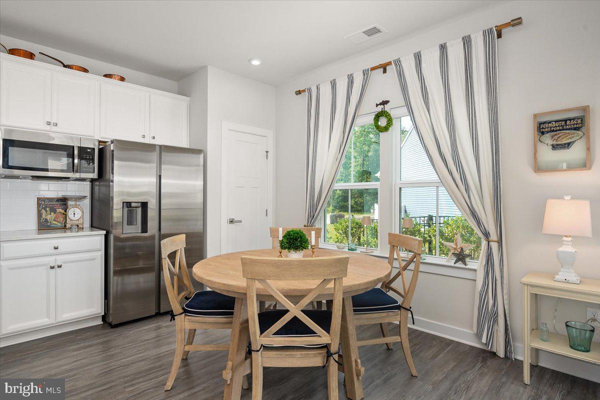 65 Old Forge Drive Ocean View, DE 19970 - Photo 18 of 69 a view of a dining room with furniture window and wooden floor