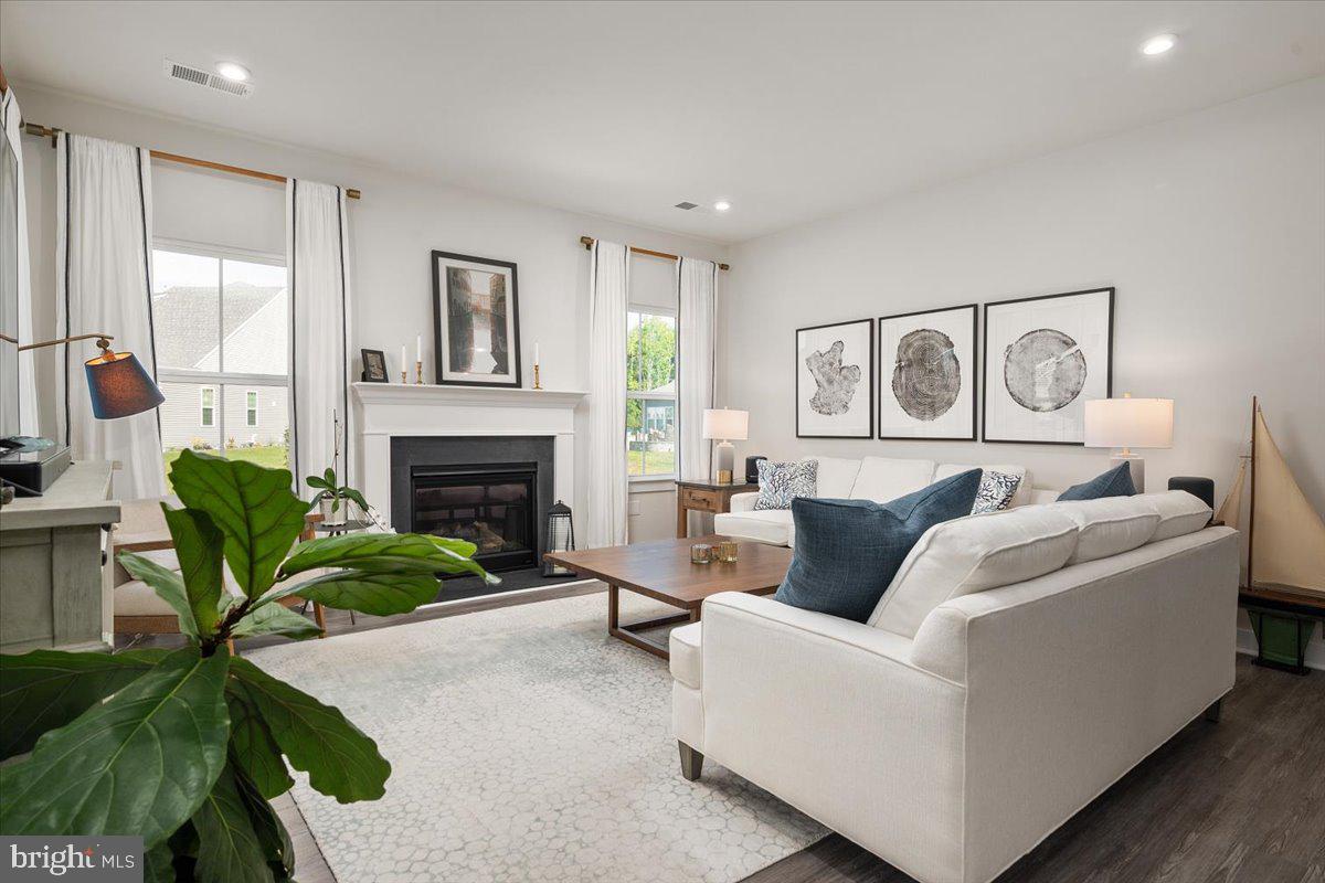 65 Old Forge Drive Ocean View, DE 19970 - Photo 3 of 69 a living room with furniture and a fireplace