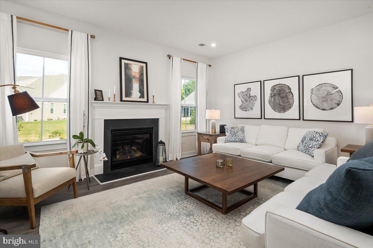 65 Old Forge Drive Ocean View, DE 19970 - Photo 4 of 69 a living room with furniture and a fireplace