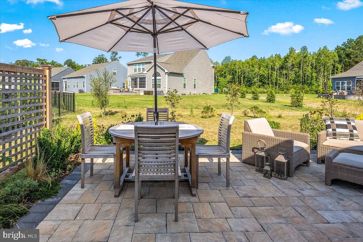 65 Old Forge Drive Ocean View, DE 19970 - Photo 43 of 69 a view of a patio with a table and chairs under an umbrella