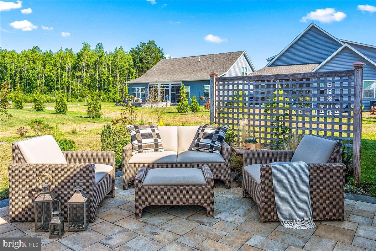 65 Old Forge Drive Ocean View, DE 19970 - Photo 45 of 69 a view of a patio with couches table and chairs and potted plants