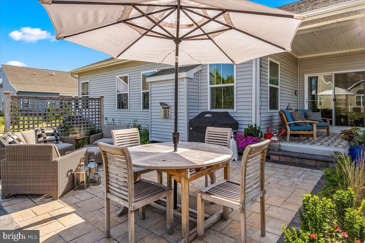 65 Old Forge Drive Ocean View, DE 19970 - Photo 49 of 69 a patio with a table and chairs and potted plants