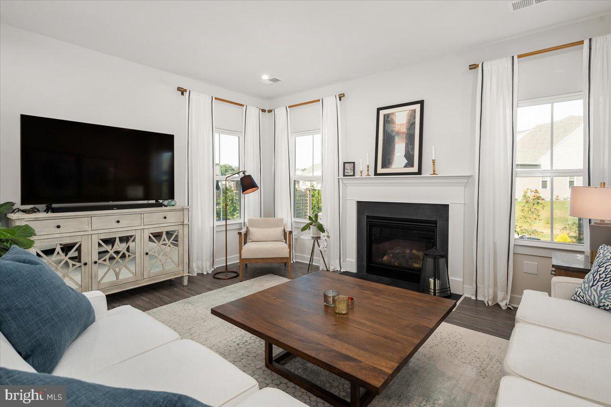65 Old Forge Drive Ocean View, DE 19970 - Photo 5 of 69 a living room with furniture a flat screen tv and a fireplace